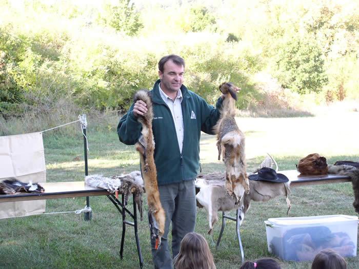 Sean Clearly from Missouri Department of Conservation shows students different hides of wild animals.