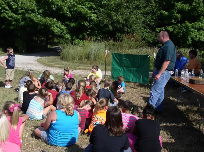 Conservation agent talking to kids.