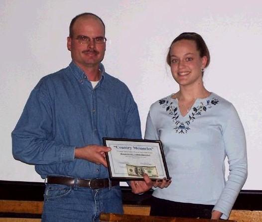 Curt Fellhoelter, Chairman of SWCD board presents Miranda with a certificate and cash.