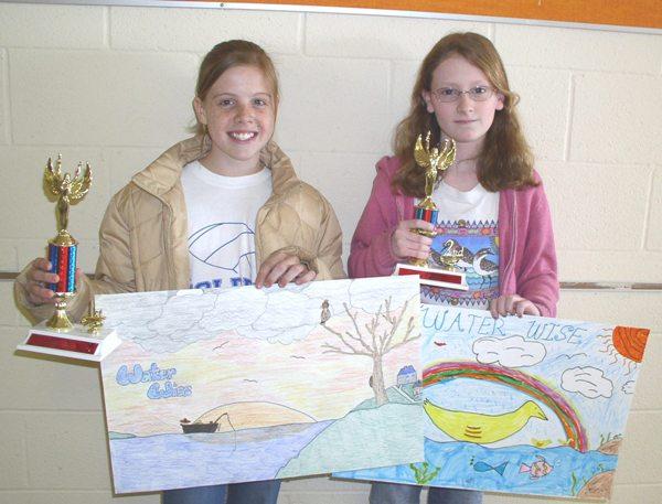 Poster contest winners with trophy and poster