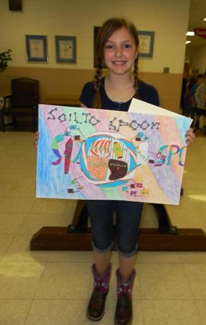 Poster contest winner posing with her poster and ribbon