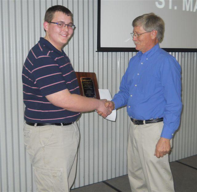 Terry receiving his award from board member, Taylor Bush