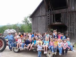 Students on hay ride pulled by a tractor