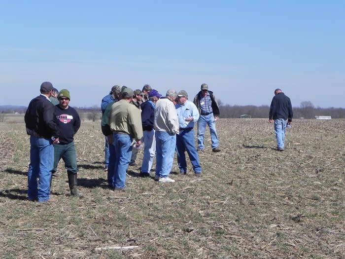 Landowners participating in the Field Day investigate the cover crop strip trials planted on the Lohmann farm.