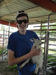 Student holding baby goat at Outdoor Safety Day 2016