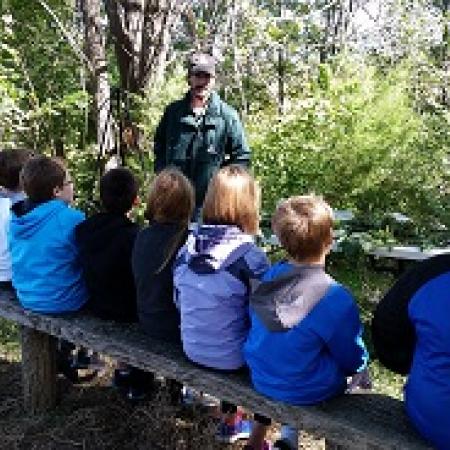 Kids in Outdoor Classroom in Atchison County, Mo - listening to MDC Agent